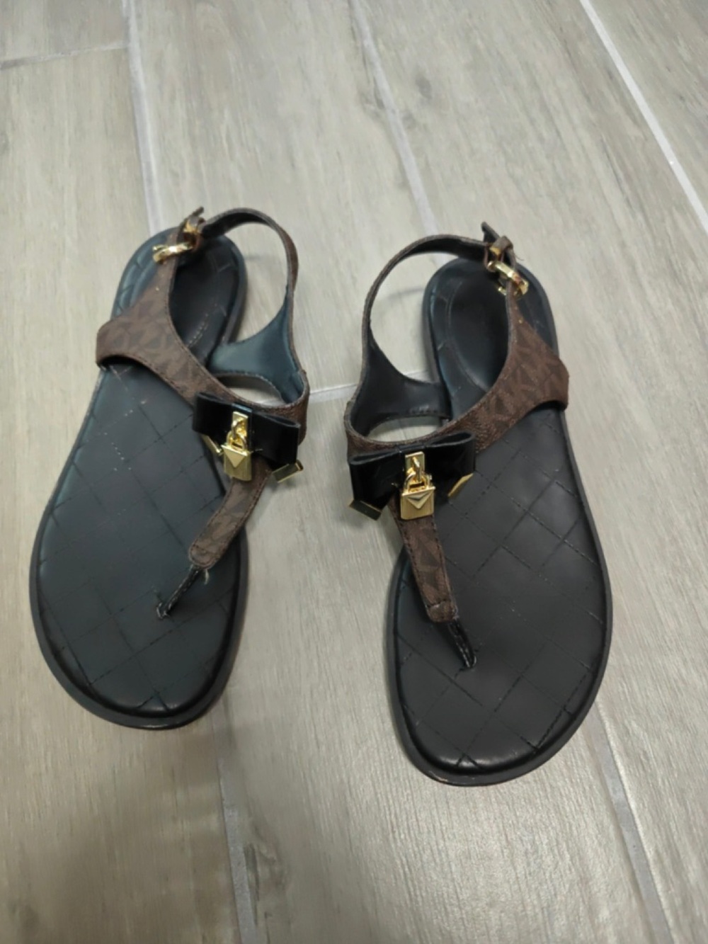 MICHAEL Michael Kors Brown and Black Logo Bow T-Strap Sandals with Gold Hardware